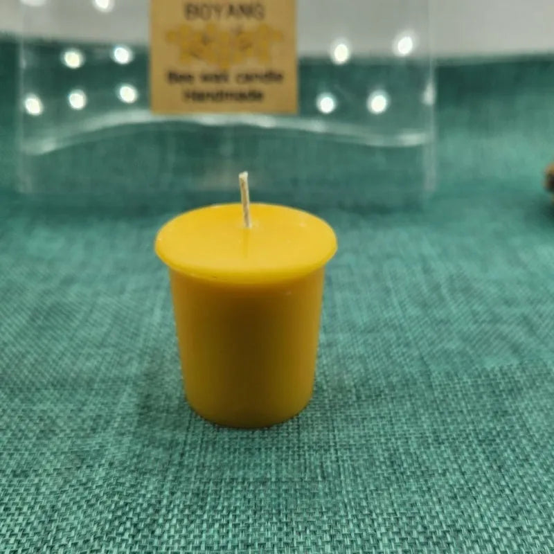 Six handmade beeswax and soy wax candles in cup shape, beeswax colour, 4.6cm x 5.2cm each, arranged on a surface