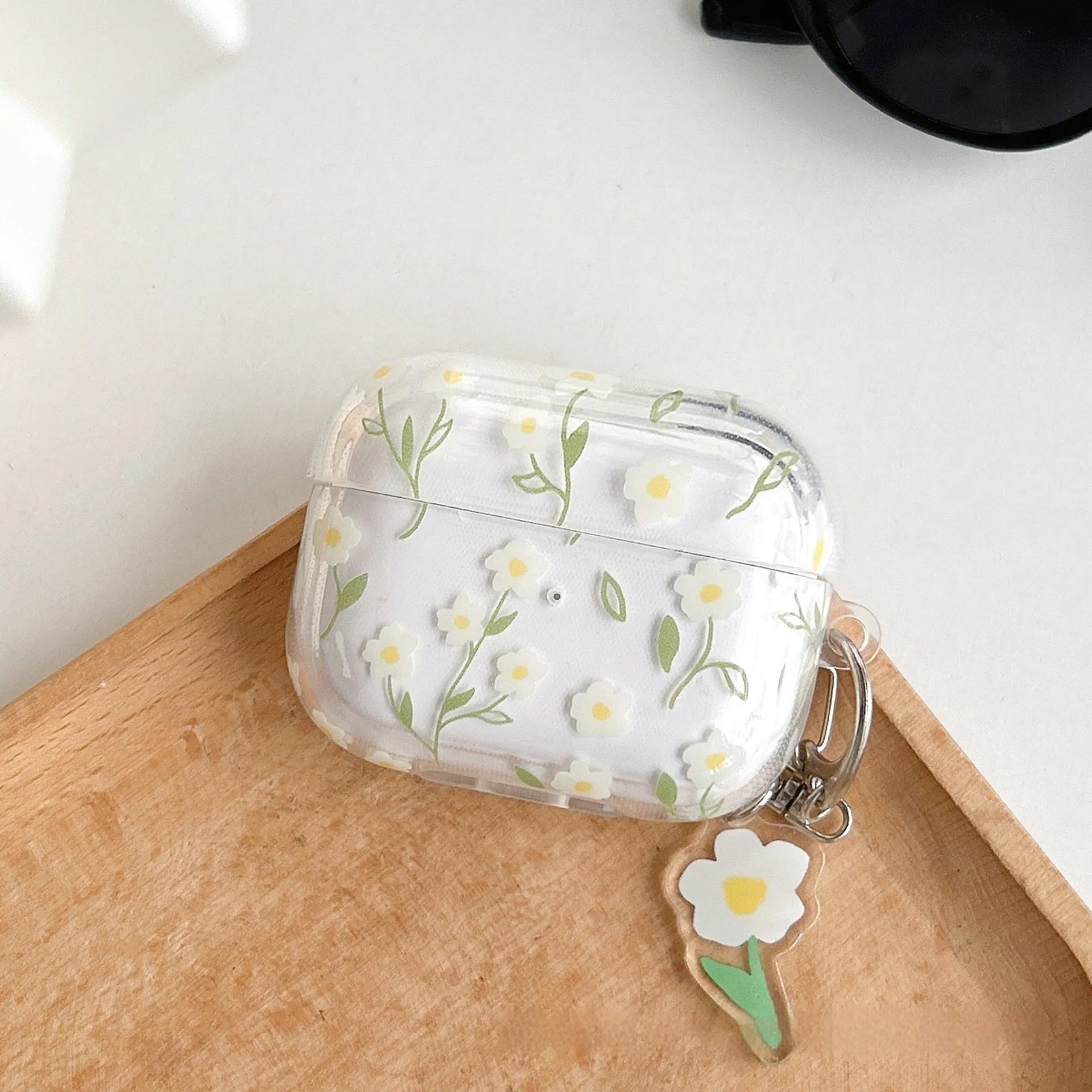 Clear TPU AirPods protective case cover with white floral design on transparent background