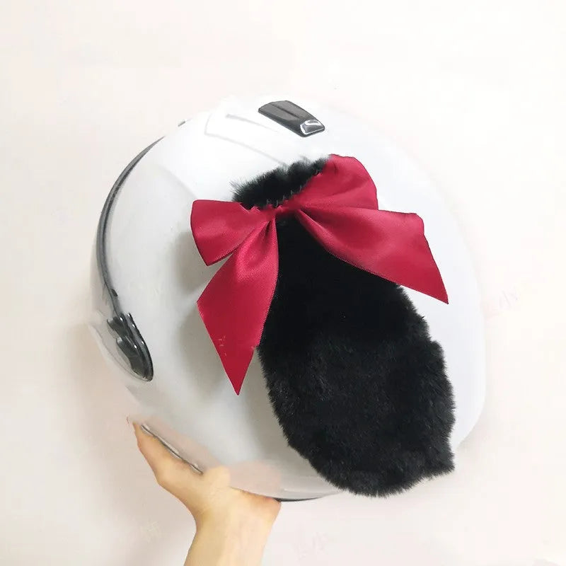 Carbon fibre rabbit ear decoration clipped onto a black motorcycle helmet, showing red colour variant.