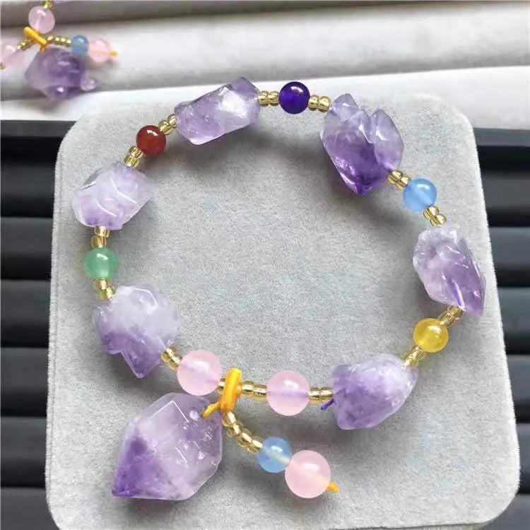Women's natural amethyst bracelet with a fu character engraved on the central bead.