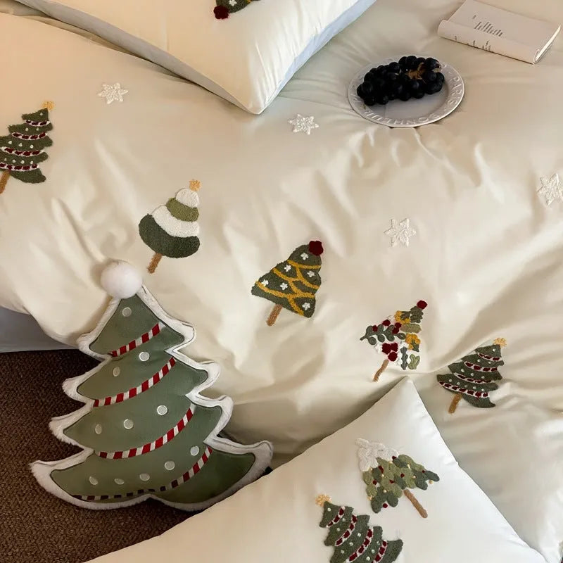 Cream blue duvet cover with raised towel embroidery of Christmas trees and flowers, part of a four-piece pure cotton bedding set.