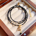Close-up of a women's multi-layer blue sand bracelet with a three-ring design and gold sand stone cut.
