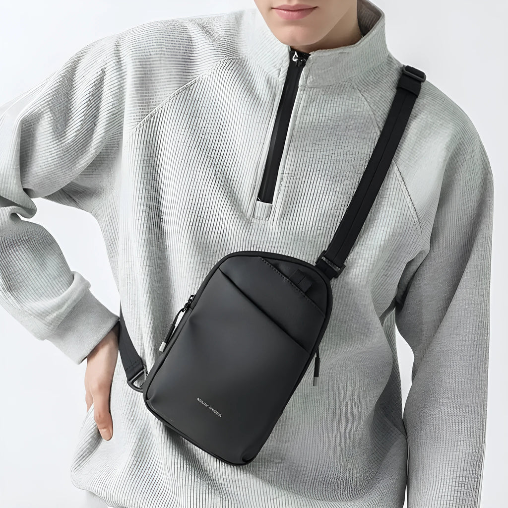 Men's black Oxford cloth crossbody bag showing sewing thread details and simple design