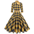 Yellow and black grid plaid turtleneck bow high waist swing dress on display showing full skirt and bow detail