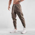 Men's loose fit ankle-tied cotton casual trousers in solid colours with multiple pockets.