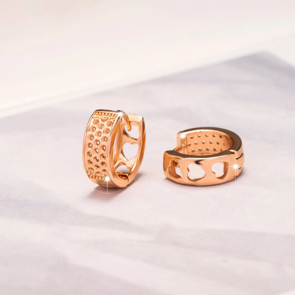 Rose gold hollowed out heart-shaped women's earrings with a three-dimensional circular design.