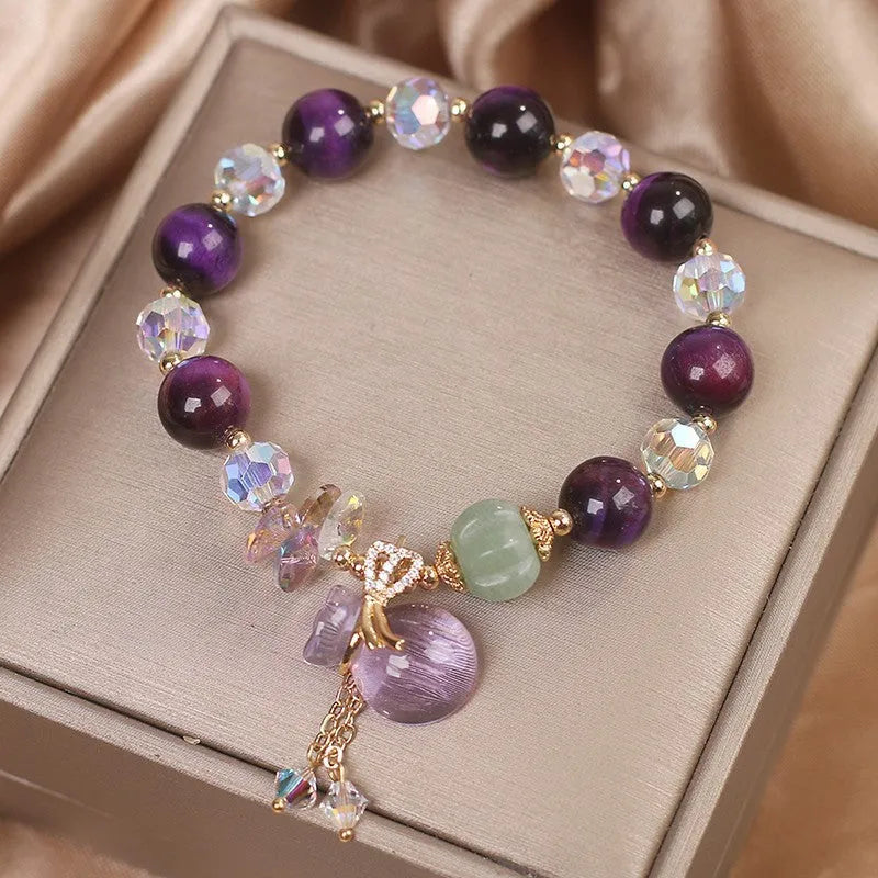 Women's forest style bracelet with purple tiger eye money bag pendant and rhinestone crystal details
