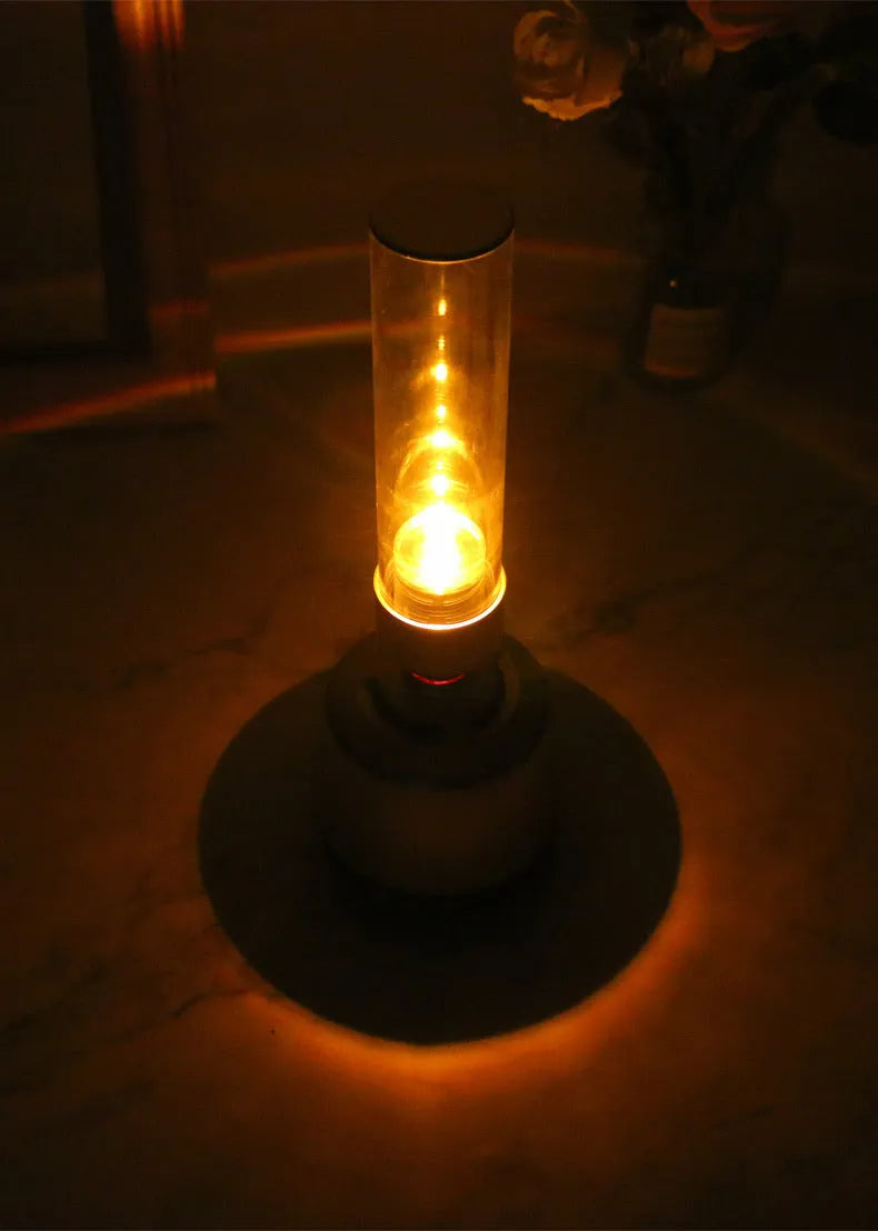 White Silver Bluetooth speaker with integrated candlelight-style night light and modern push buttons.