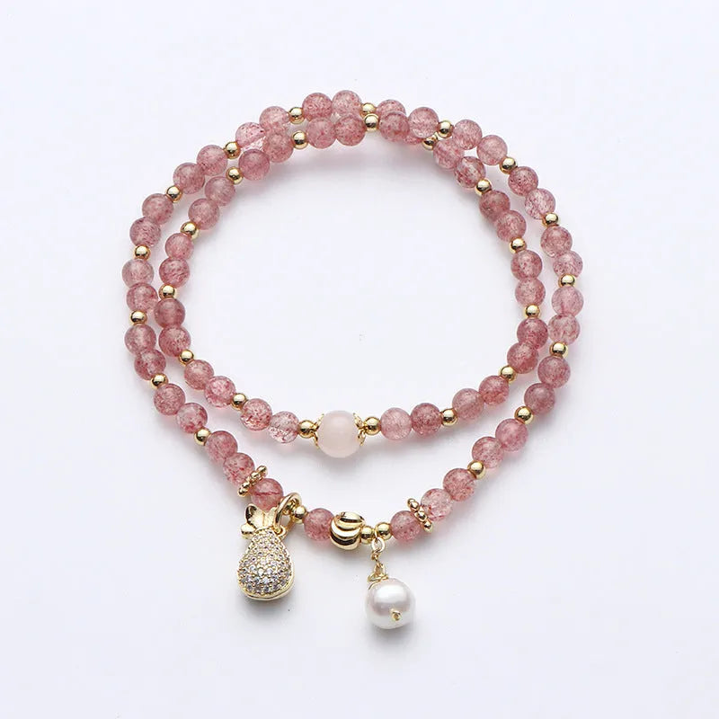 A geometric wallet bracelet for women made from pink strawberry quartz crystal.