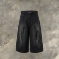Men's black denim shorts with flame embroidery and a cropped patch on the leg.