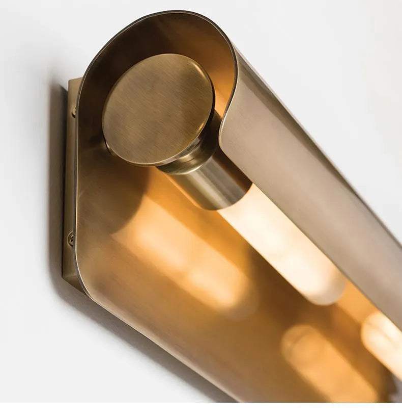 Simple modern copper wall lamp with warm light, 26cm long, on a living room wall