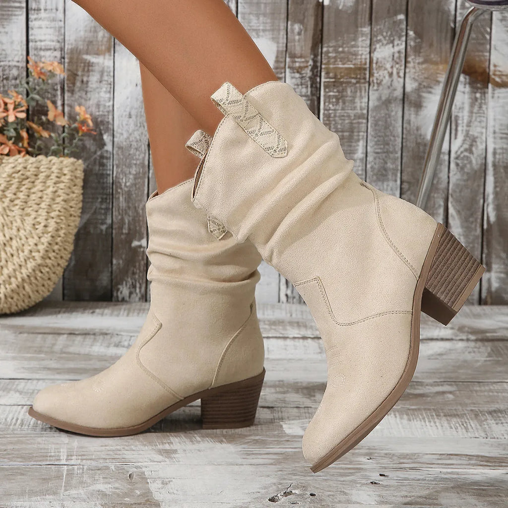 Mid-calf suede boots with a block heel and pointed toe in lotus root colour on a neutral background.