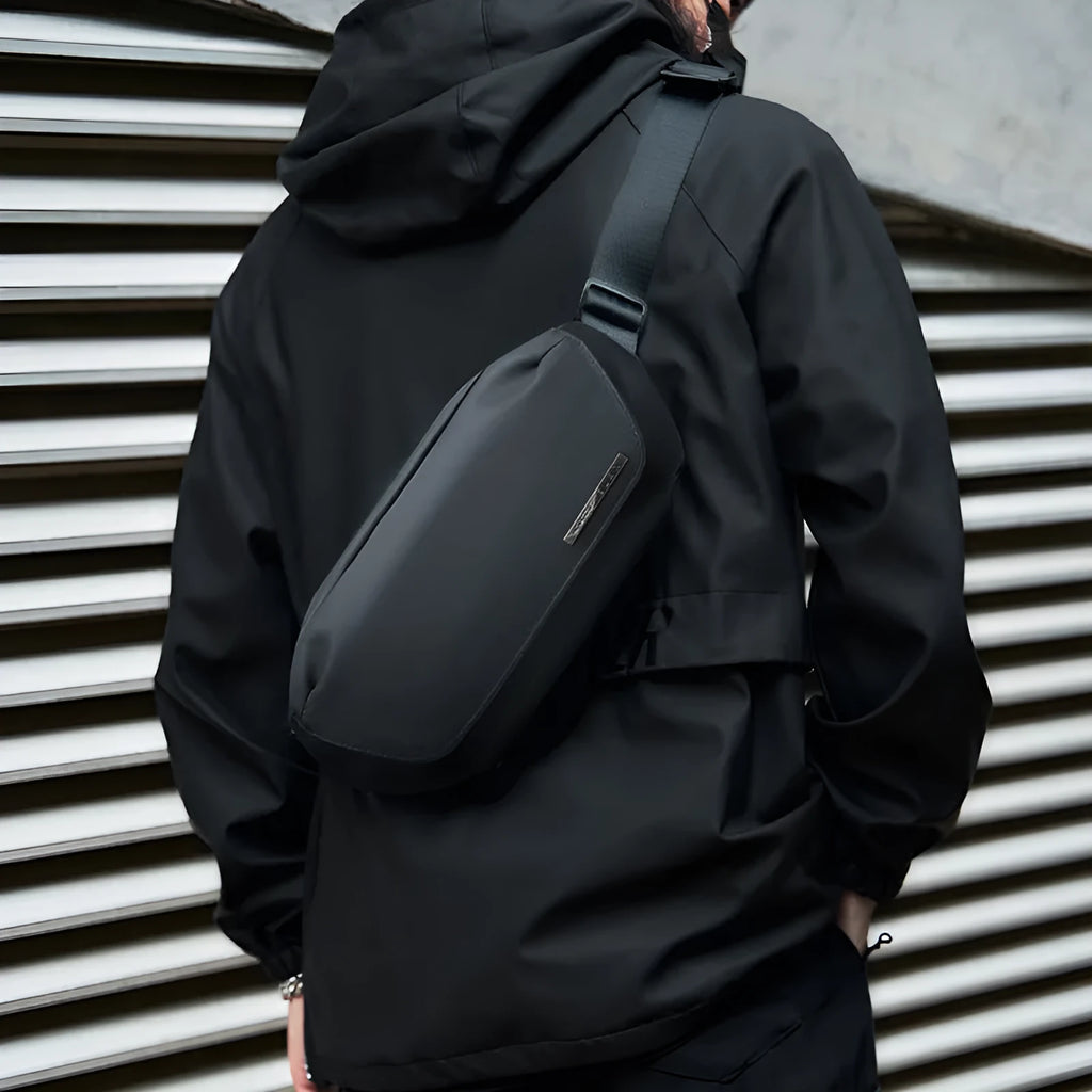Black men's messenger bag made from Oxford cloth with a one-shoulder strap.