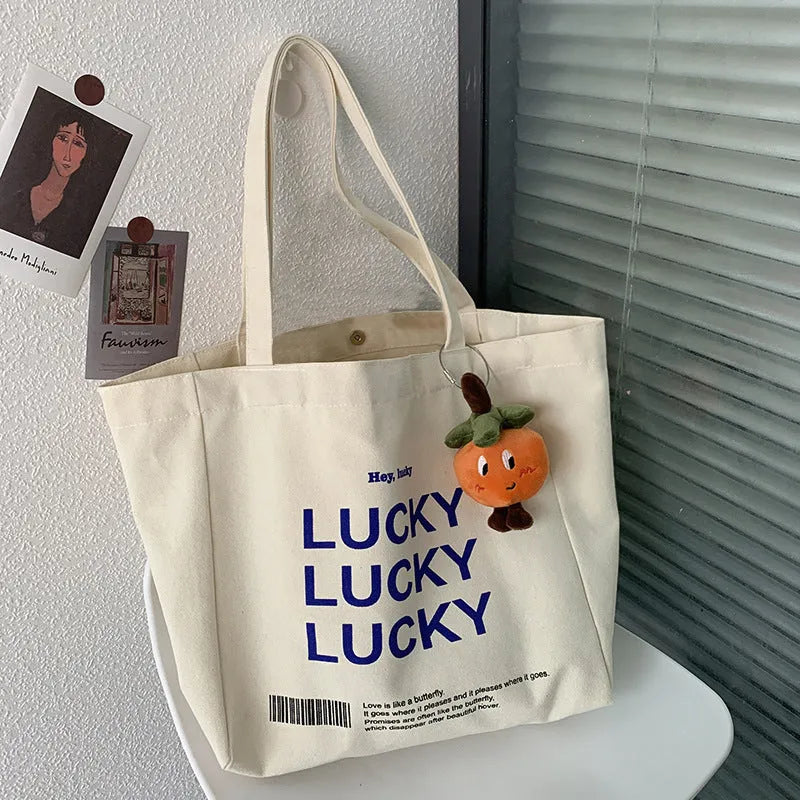 Natural canvas tote bag 32x31.5x10cm with bottom and side panels, small pocket, and metal magnet buckle