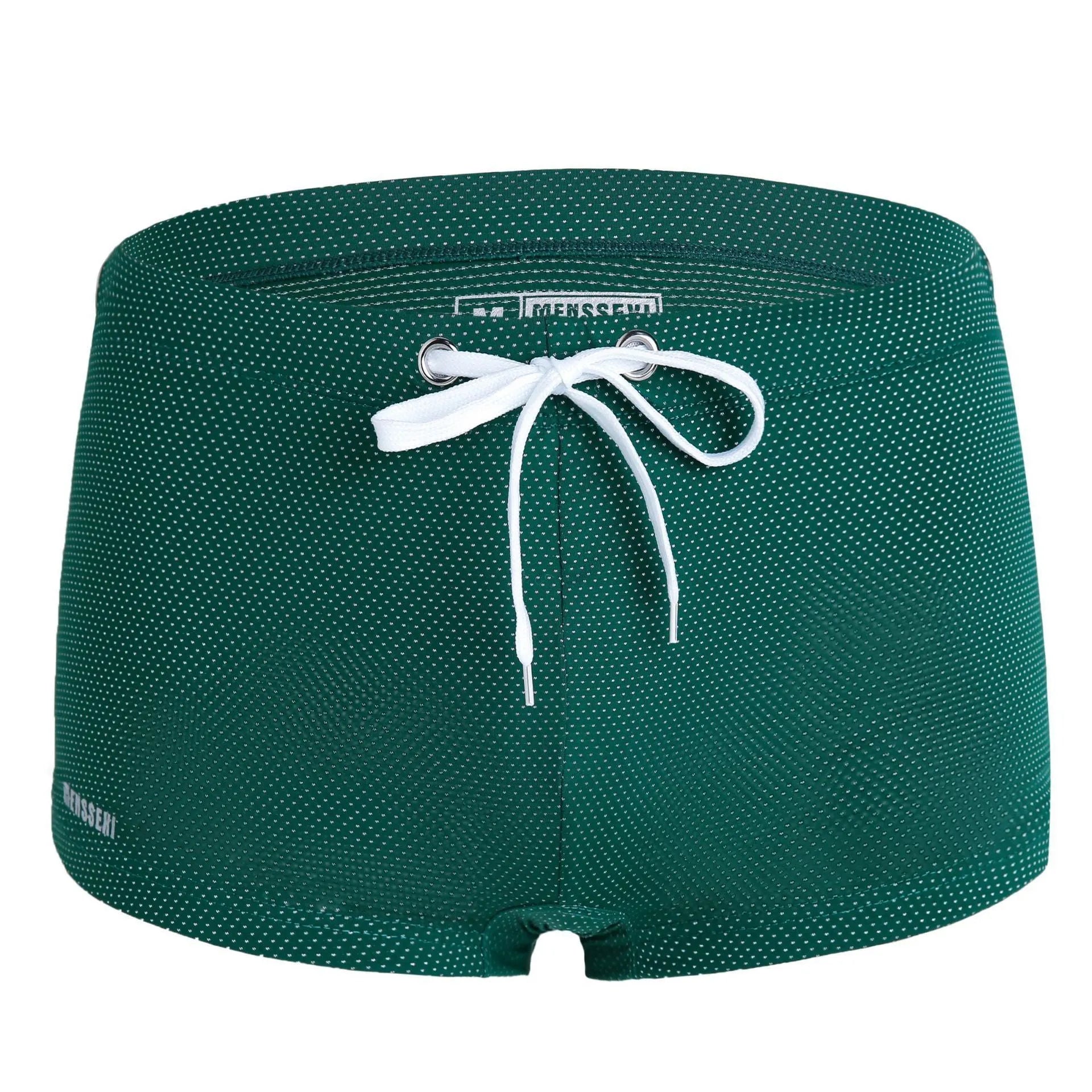 Men's solid colour low waist swimming trunks in nylon, shown in multiple colours including fluorescent green and black.