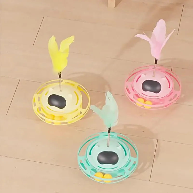 Pink rotating cat tumbler toy measuring 17 by 10 centimetres on a flat surface