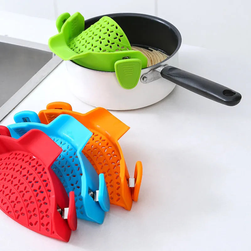 Silicone and stainless steel pot drain stopper kitchen gadget in assorted colours.