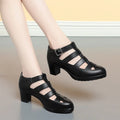 Women's beige closed toe sandals with chunky heel, woven ankle-strap buckle, and back zipper on a plain background