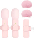 Pink K1K9 one-drag wireless microphone with receiver, charging cable, and hairball windshield on a table