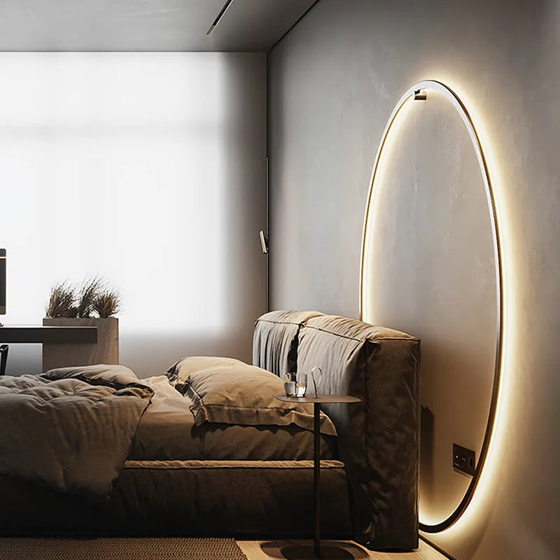 Minimalist black ring wall lamp with acrylic shade mounted on a bedroom wall