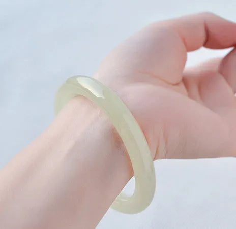 Round bar jade bracelet showing natural stone patterning with size measurement guide