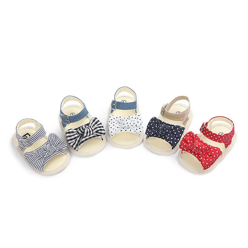 Black and white velcro fastening baby shoes for toddlers, showing low tube height design.