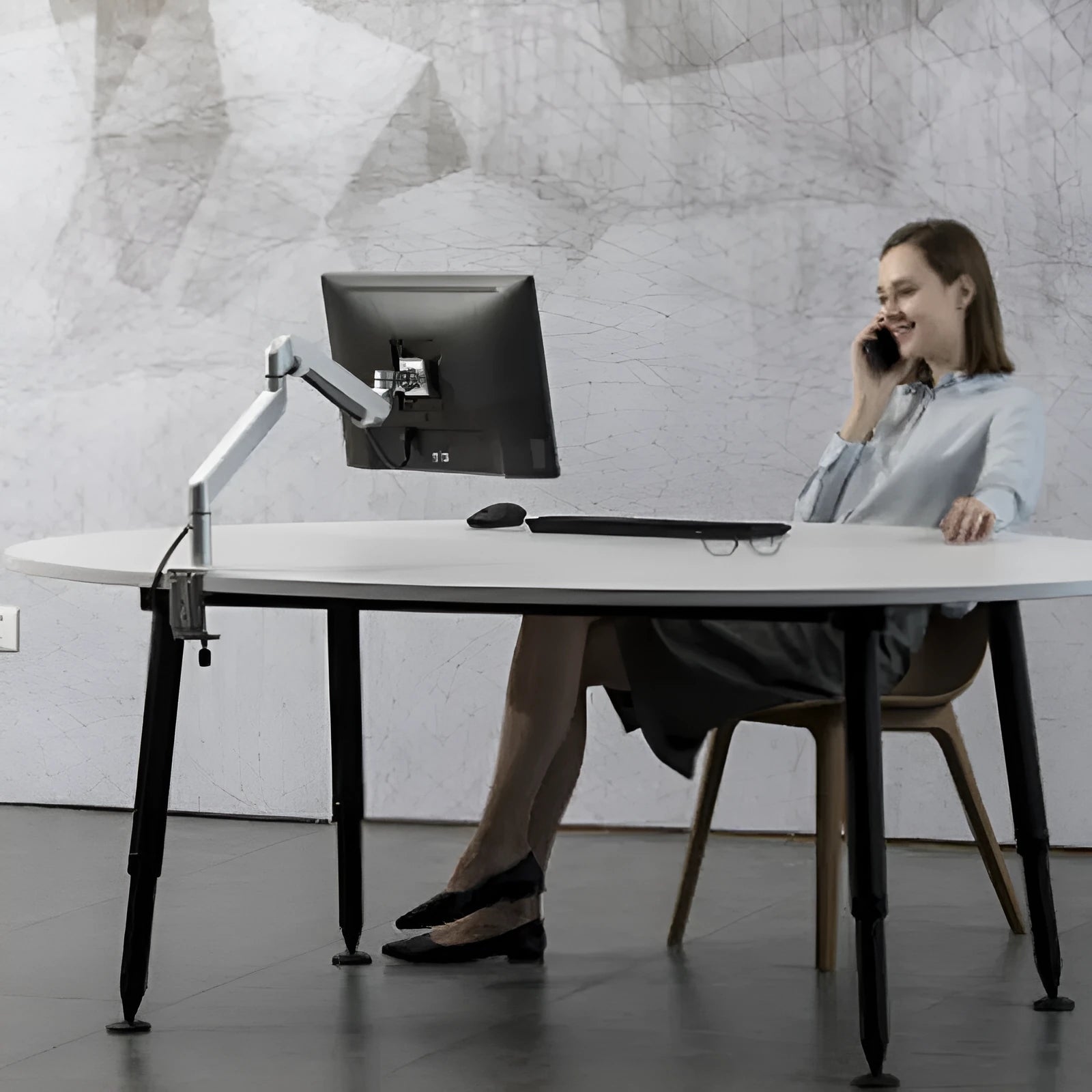 Aluminium laptop stand with adjustable arm bracket in silver colour on desk