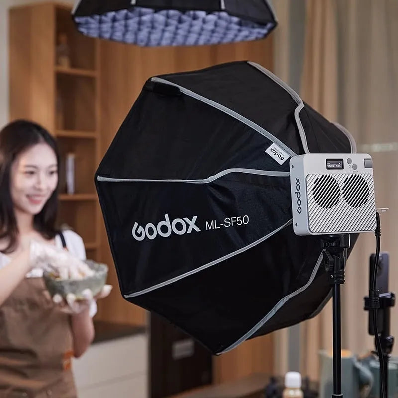 ML100Bi aluminium alloy photography LED fill light with lenses and battery handle on a stand.