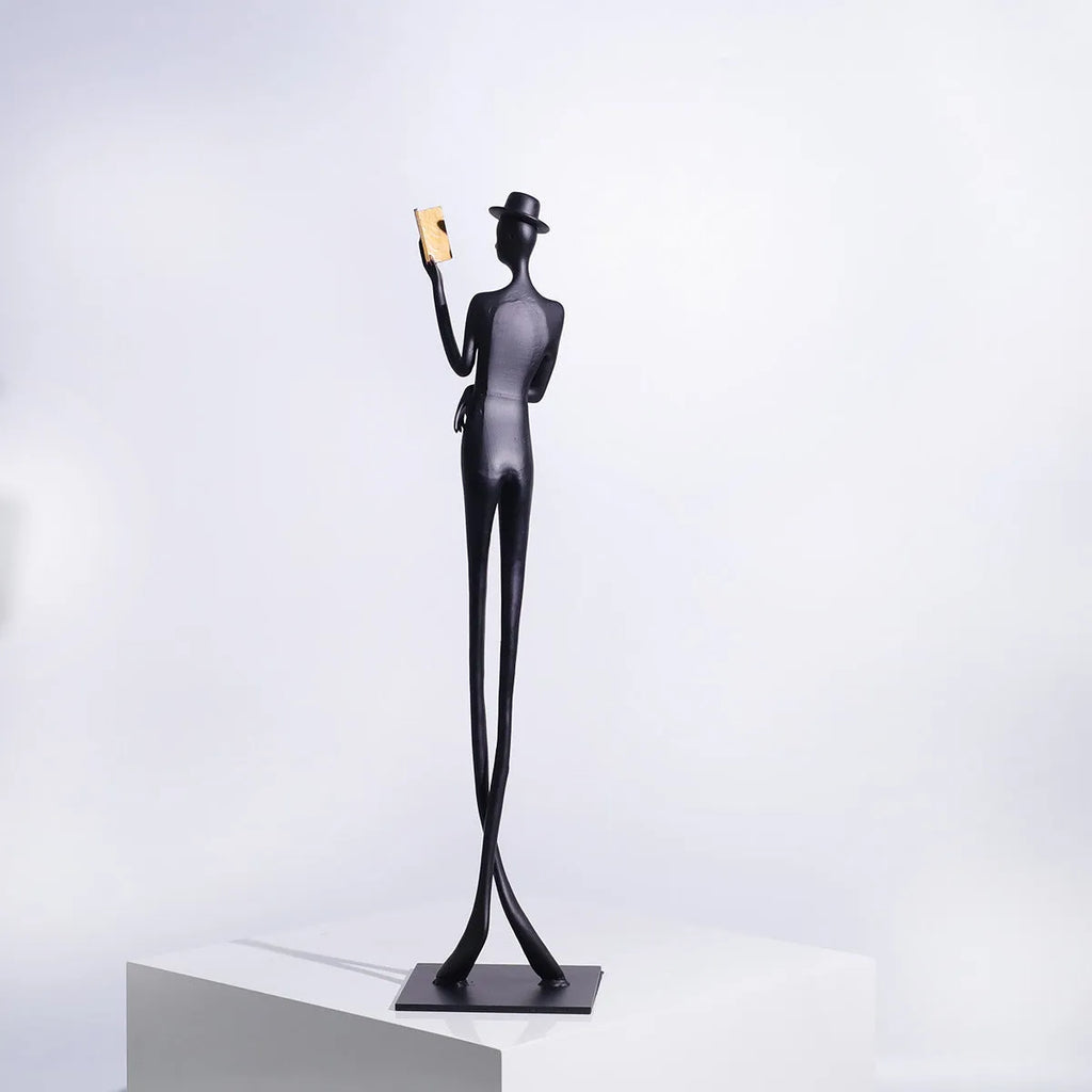 Black aluminium reading woman desktop sculpture with modern geometric design