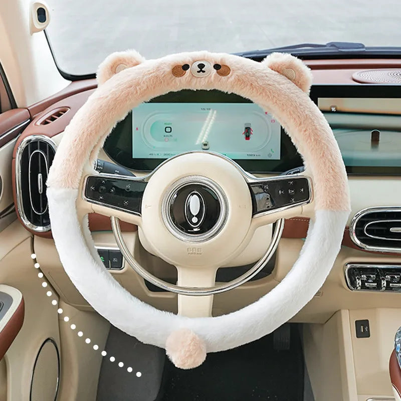 Plush faux fur steering wheel cover with embroidered cartoon bear face, fitted on a car steering wheel