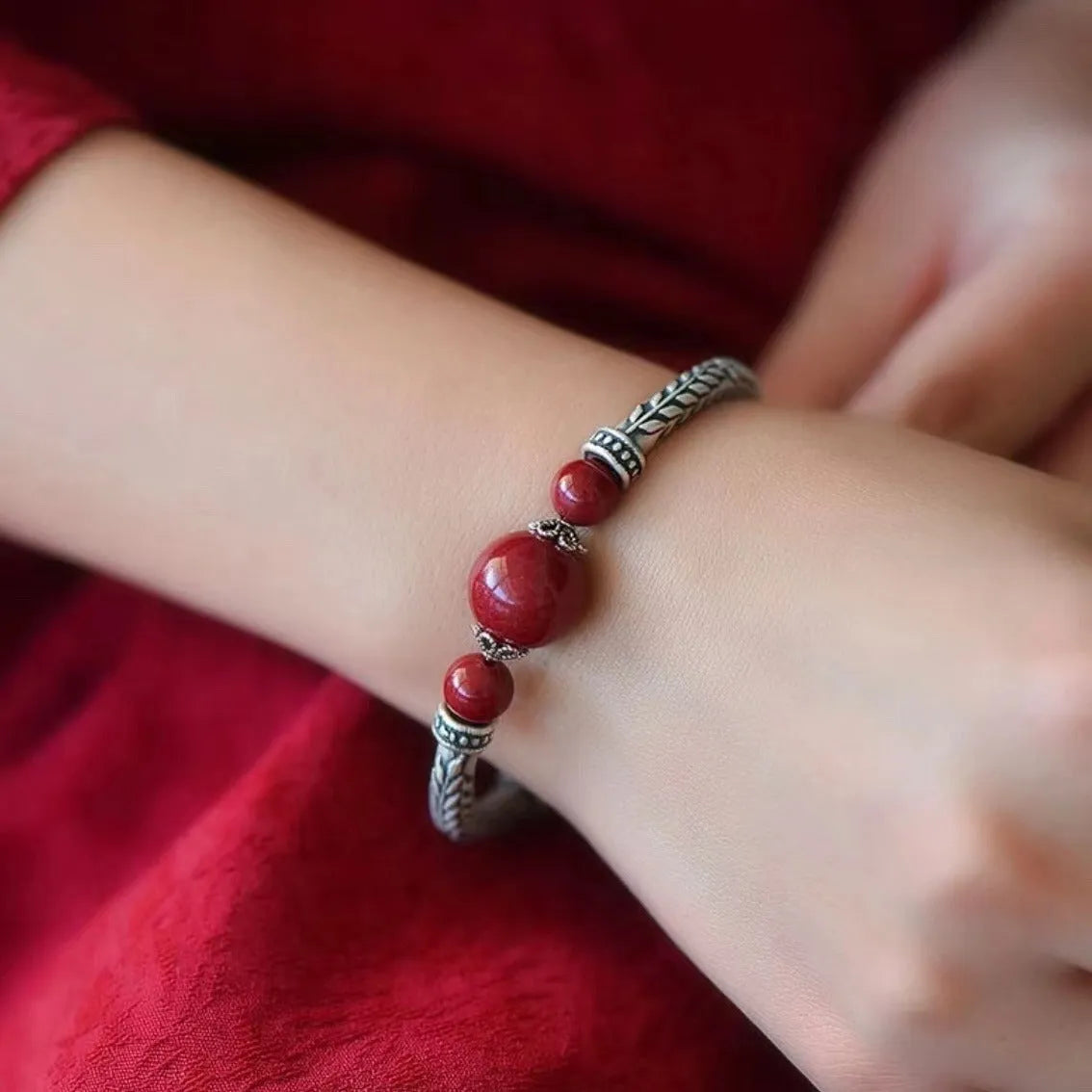 Pure silver 999 cinnabar bracelet with 10mm round retro geometric beads on neutral background