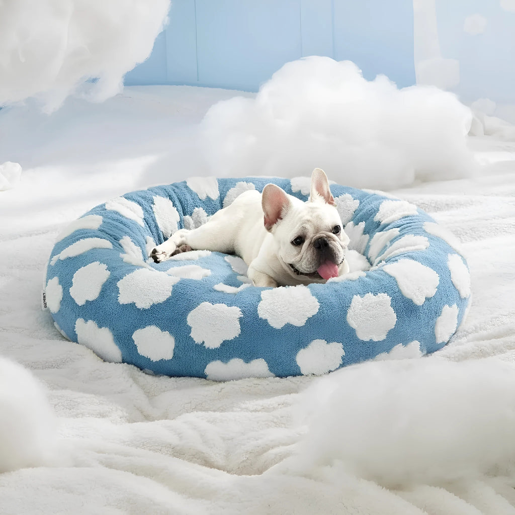 Round plaid dog bed with raised sides on a plastic base, shown in a sea blue and white colour.