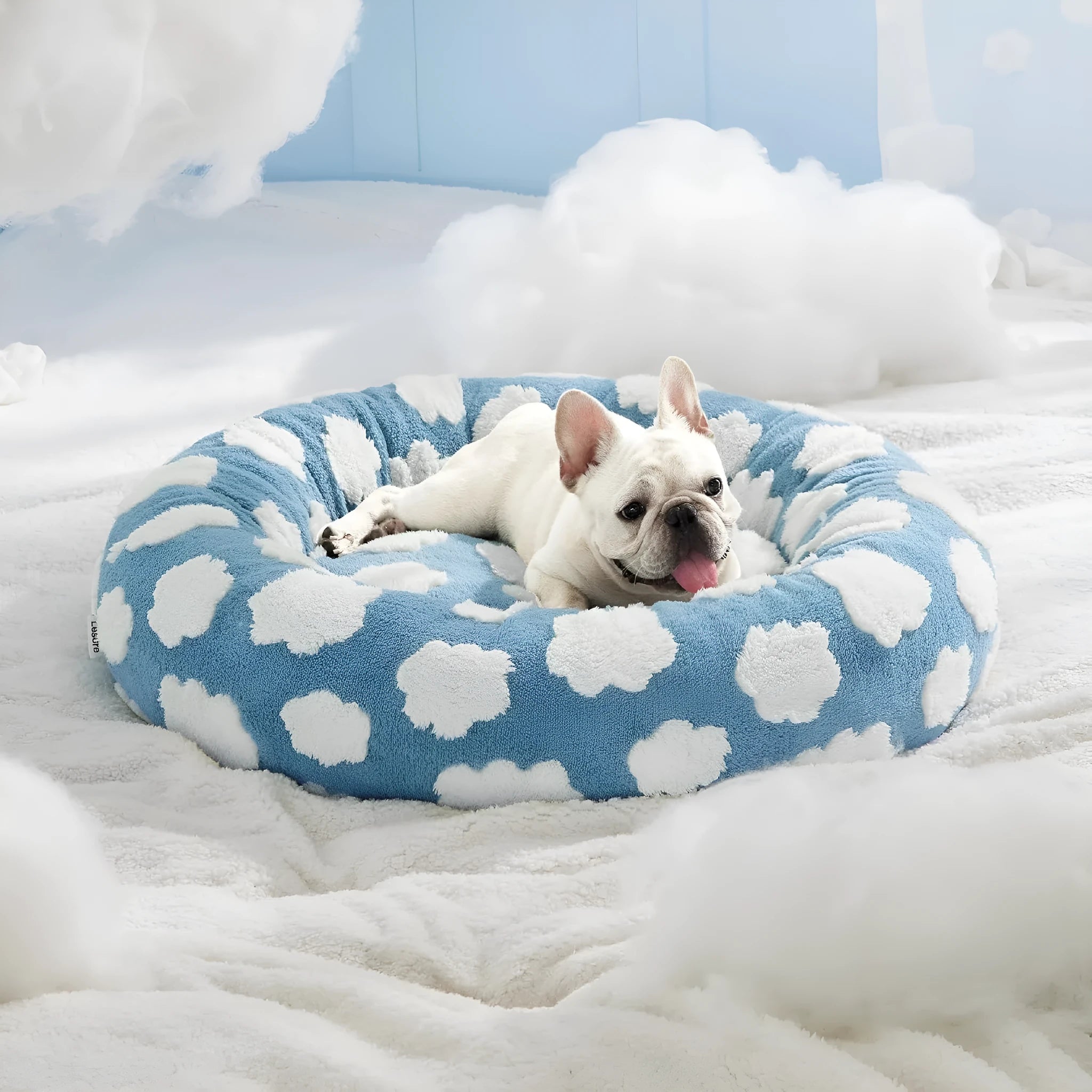 Round plaid dog bed with raised sides on a plastic base, shown in a sea blue and white colour.