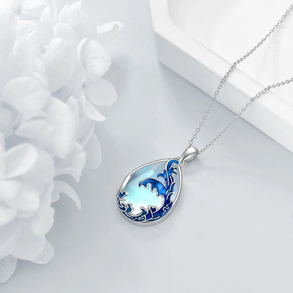 Close-up of a moonstone blue alloy heart pendant necklace on a 20-inch chain.