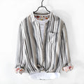 A man wearing a red and grey striped linen casual shirt with long sleeves and a loose fit.