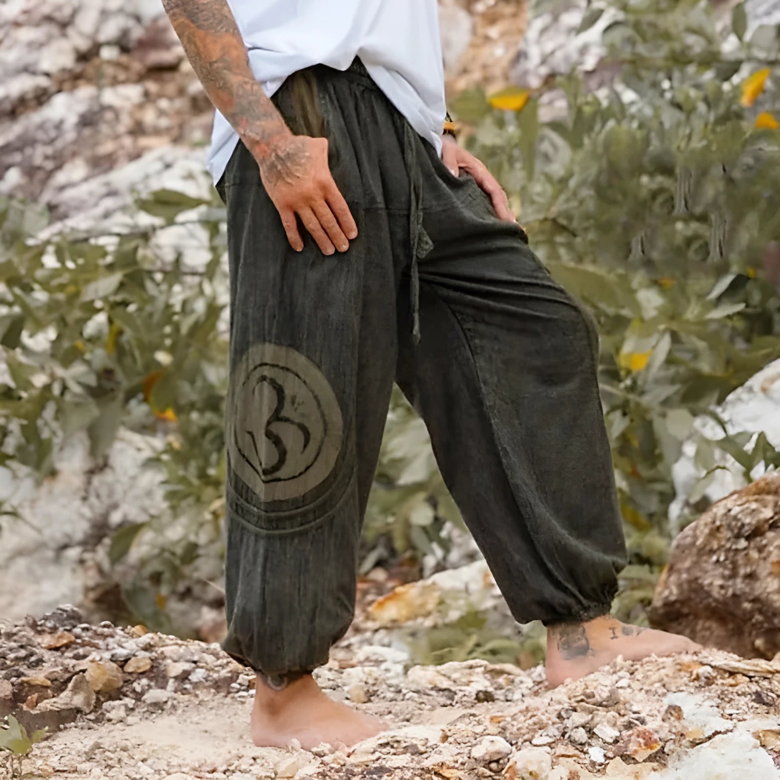 Men's dark green ethnic pattern casual ankle-tied trousers on model, polyester fabric