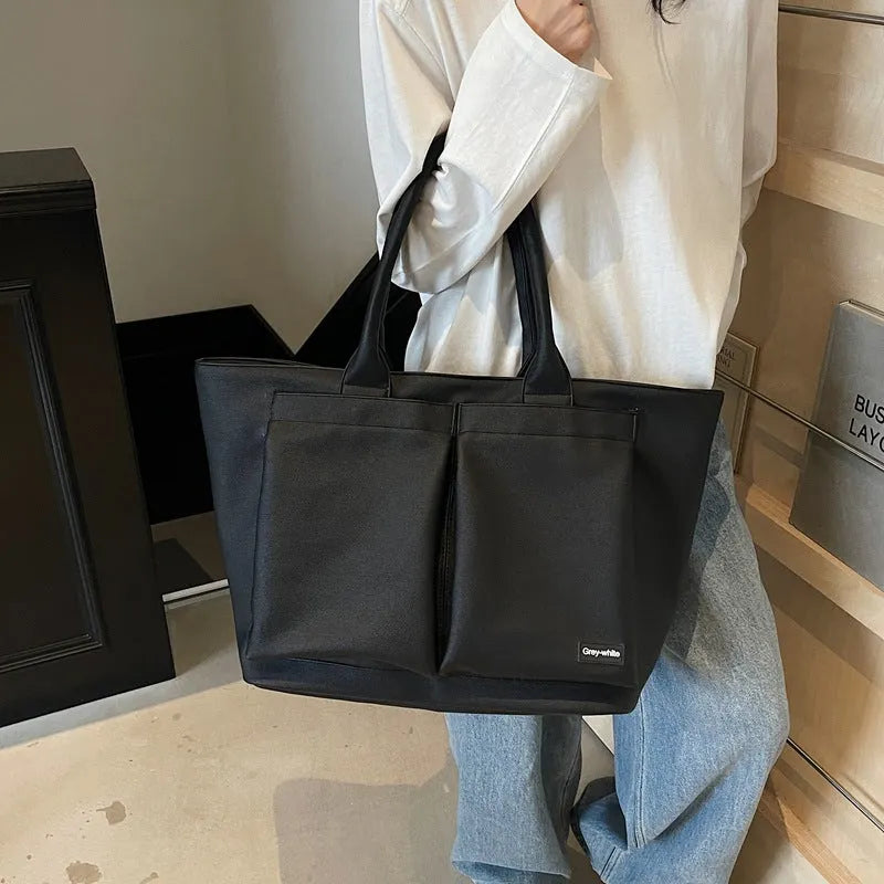 Lightweight PU shoulder bag with expandable 20-35 litre capacity in black, white or green