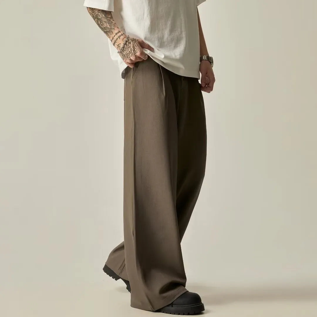 Men's black wide-leg casual trousers with vertical stripes and an elastic waistband.
