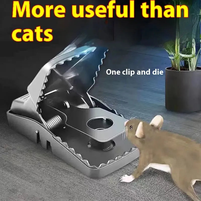 A galvanised metal humane live-catch mouse trap with a single door, shown on a wooden surface.