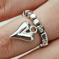 Handmade gold and white elastic beaded ring with a geometric love heart design.