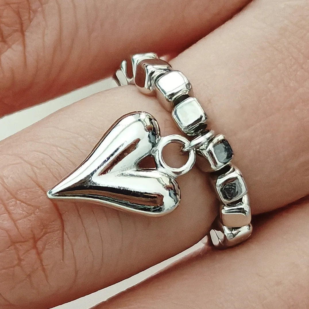 Handmade gold and white elastic beaded ring with a geometric love heart design.