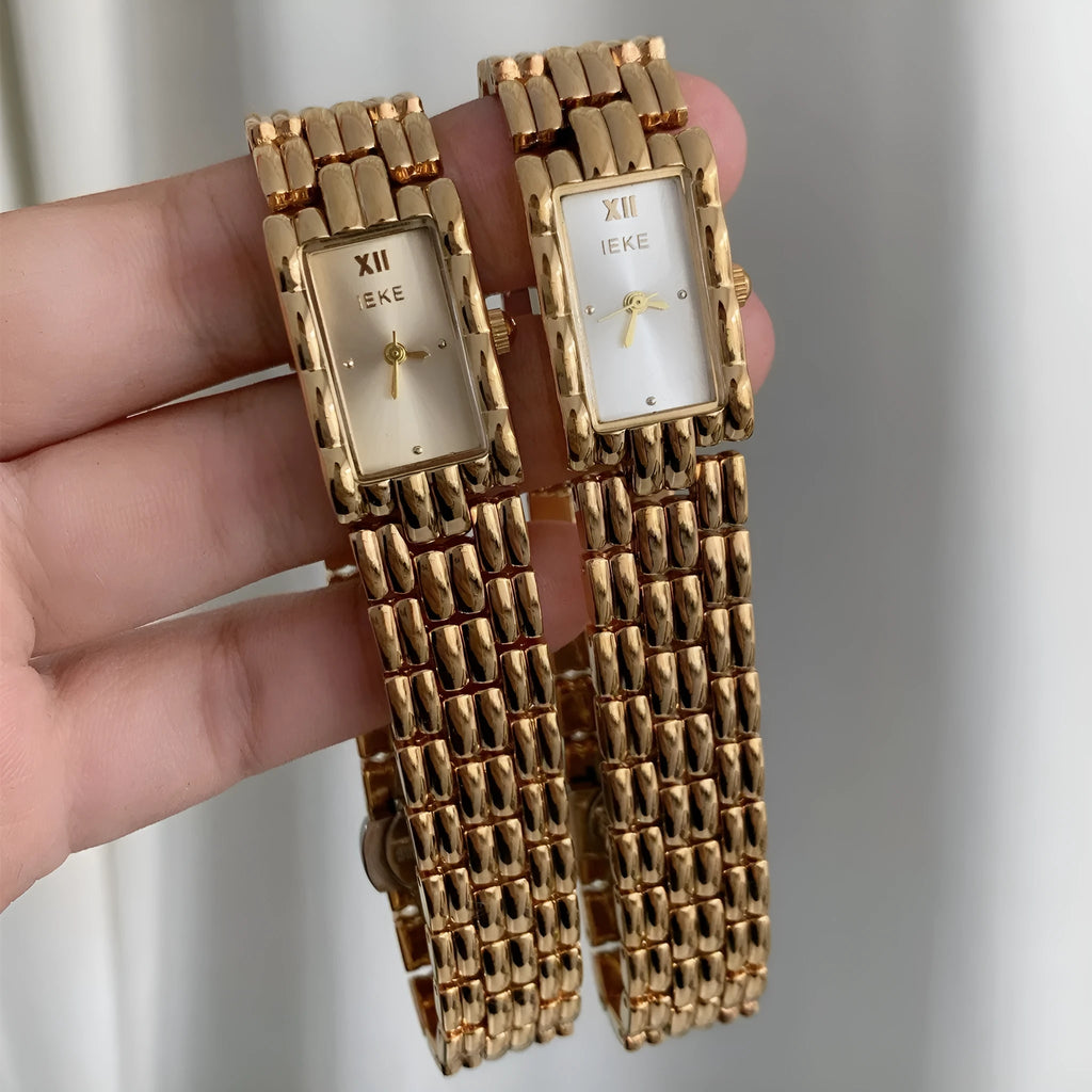 Mid-ancient style women's watch with butterfly buckle on wrist, showing gold and silver strap options