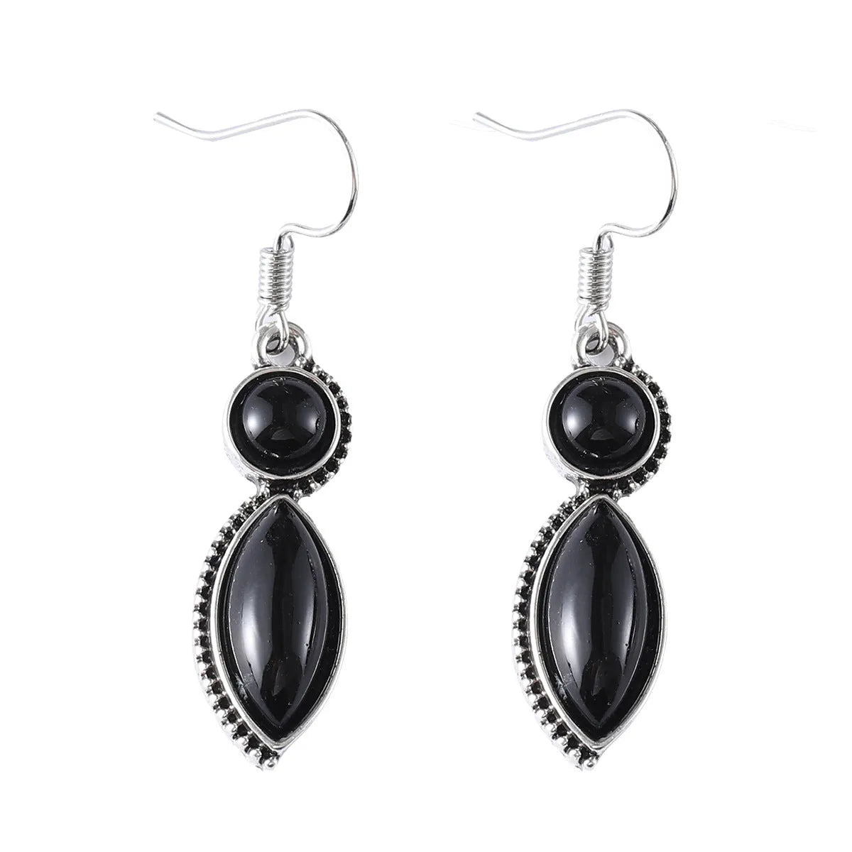 Close-up of geometric vintage pendant earrings in black and purple with a metallic shine.