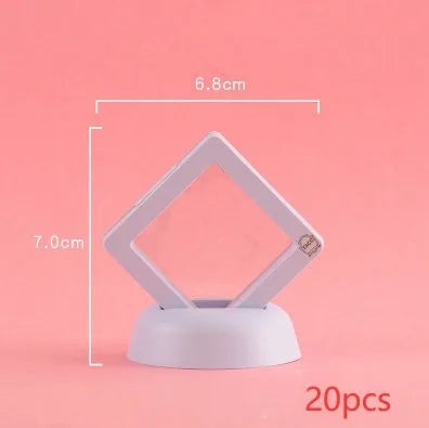 3D floating display case holding a coin suspended between transparent membrane sheets, black frame