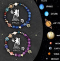 Close-up of two adjustable natural stone bead bracelets with metal zodiac charms on a wooden surface.