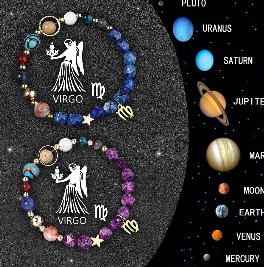 Close-up of two adjustable natural stone bead bracelets with metal zodiac charms on a wooden surface.
