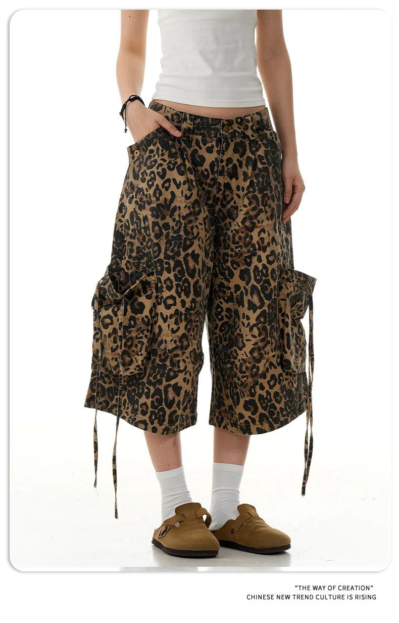 Women's high-waisted leopard print cropped trousers with a loose straight leg and button fly.