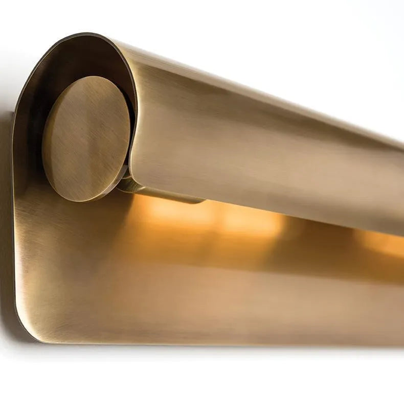 Simple modern copper wall lamp with warm light, 26cm long, on a living room wall