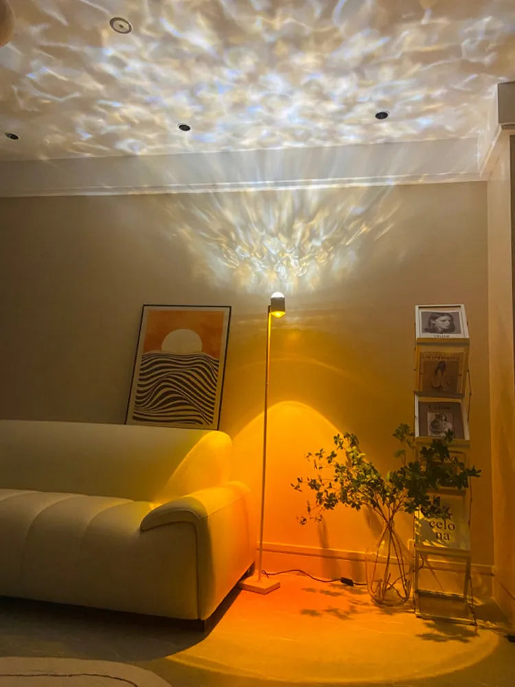 Modern water wave projection floor lamp in sunset red with four colour cards on a living room floor