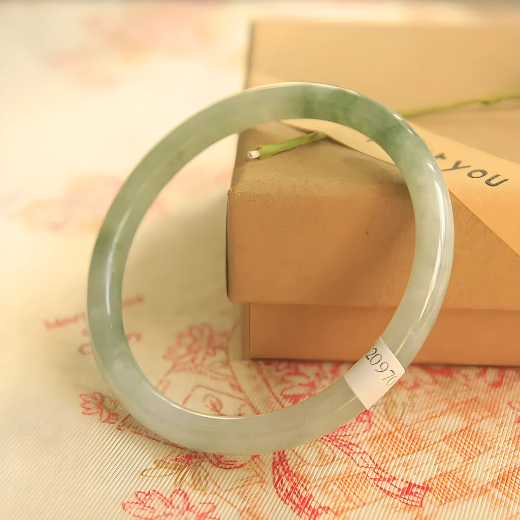 Traditional green jade waxy Chinese bracelet with geometric design showing 10mm profile